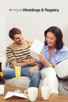 a man and woman sitting on a couch with gifts for their wedding or special occasion