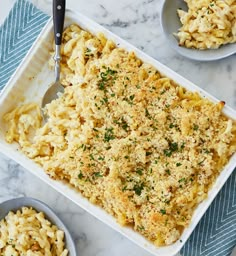 macaroni and cheese in a casserole dish on a marble table