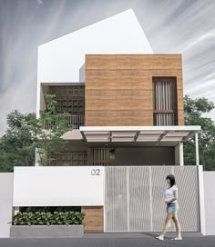 a woman walking in front of a modern house