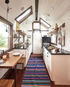 the kitchen is clean and ready to be used as a dining area in this tiny home