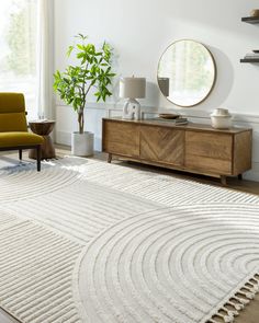 a living room with a rug, chair and mirror