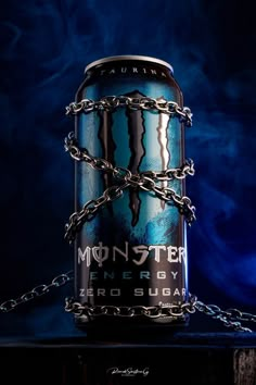 a can of monster energy drink with chains on the chain around it's neck