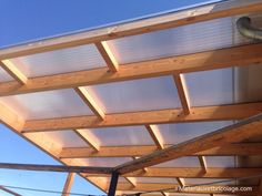 the roof of a building is covered with wood planks and metal bars that are attached to the side of it