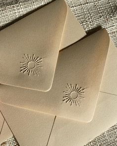 three envelopes with sun stamps on them