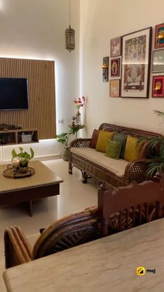 a living room filled with furniture and a flat screen tv mounted to the side of a wall