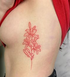 a woman with a tattoo on her stomach has a red flower in the shape of a heart