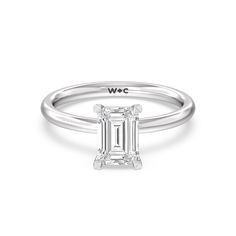 a white gold ring with an emerald cut diamond