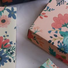 two boxes with different designs on them sitting next to each other, one has a flower pattern