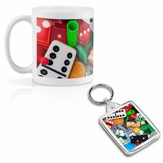 a coffee mug with a keychain that is filled with dices and other items