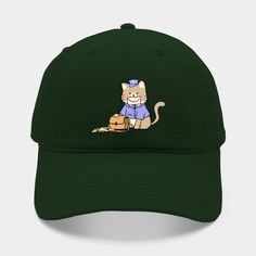 a green hat with a cartoon cat sitting on the ground wearing a blue shirt and jeans