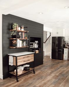 a kitchen with wood floors and black walls