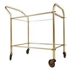 a gold metal cart with wheels on it