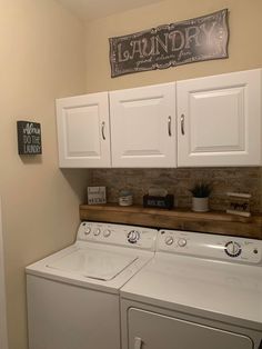 a white washer and dryer sitting in a laundry room next to each other