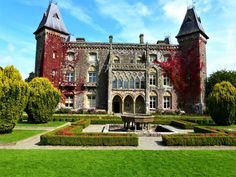 a large building with lots of plants in front of it