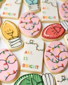 decorated cookies are arranged on a table with the words all is bright written across them