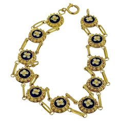 This Traditional Portuguese Bracelet is a magnificent example of classic Portuguese jewelry craftsmanship, combining rich materials and intricate design techniques. Made from 19kt yellow gold, the bracelet showcases the luxurious and warm tone of high-carat gold, offering a timeless and elegant appeal. The bracelet features exquisite blue and white enamel flower detailing, a hallmark of traditional Portuguese design. The vibrant blue and pristine white enamel are expertly applied to create a str Elegant Blue Bracelet With Intricate Design, Elegant Blue Bracelets With Intricate Design, Luxury Filigree Round Bracelets, Luxury Blue Gold Bracelet For Formal Occasions, Victorian Filigree Bracelets In Yellow Gold, Victorian Yellow Gold Bracelet With Filigree, Yellow Gold Filigree Bracelets, Victorian Yellow Gold Filigree Bracelets, Luxury Blue Gold Jubilee Bracelet