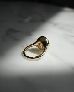 a gold ring sitting on top of a white counter