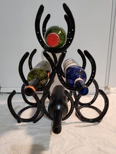 a spider - like wine rack with several bottles in it