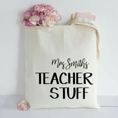 a tote bag that says, my santas teacher stuff with flowers on it