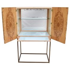 an open wooden cabinet with glass shelves