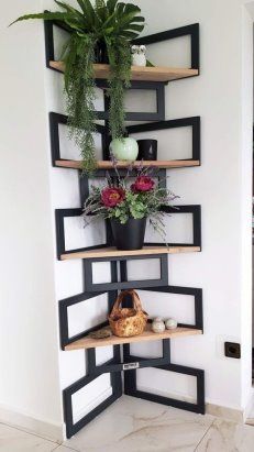 a corner shelf with potted plants on it