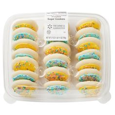 a plastic container filled with lots of colorful cookies