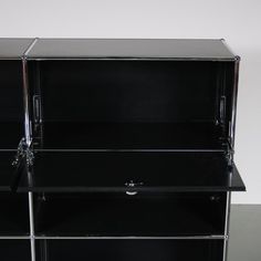 a black glass shelf with three shelves on each side