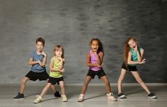 five young children are standing in a line