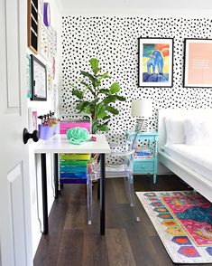 a room with white walls and black and white polka dot wallpaper on the walls