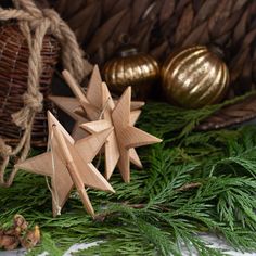 a wooden star sitting on top of a table next to christmas decorations