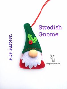 a christmas ornament with a green and red hat on it's head