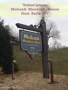 the sign for mohonk mountain house is in front of some trees and bushes