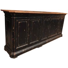 an old black cabinet with wooden doors and drawers on the bottom shelf, isolated against a white background