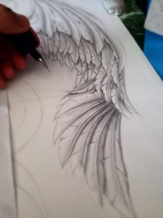 someone is drawing something with pencils on paper