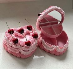 a pink cake with cherries in the shape of a heart shaped box and mirror