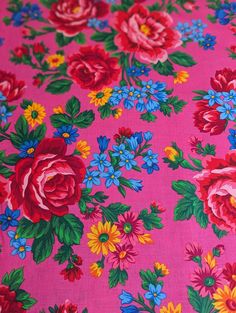 a pink background with red, yellow and blue flowers