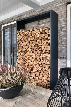 a large pile of wood sitting on top of a wooden table next to a window