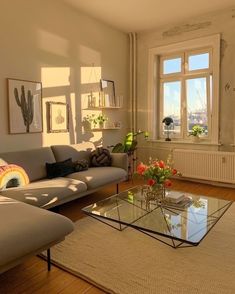 a living room with two couches and a coffee table in front of a window