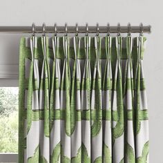 a green and white curtain hanging on a window