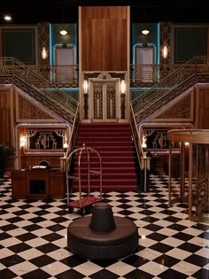 the stairs are decorated with black and white checkered flooring, which has red carpet