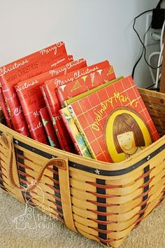 a basket filled with books sitting on top of a carpet