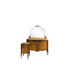 an antique dressing table with mirror and stool