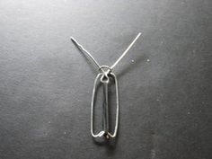 a piece of metal sitting on top of a black table next to a pair of scissors