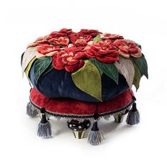 an ottoman covered in flowers and tassels