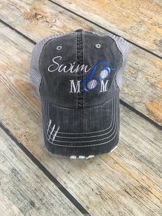 "These stylish adult trucker hats are made with a soft distressed material. They come with Velcro adjustable strap on the back. This hat features the saying Swim Mom! Perfect for the mom that spends the day at the pool!! Each hat is custom made, so you can choose your colors and even a different saying!! *Choose your hat color from the drop down box. Select your design-Hat as shown (black trucker hat with white & black thread) or Hat with number added to the bill. In the notes to seller box: Swim Team Gifts, Monogram Box, Lacrosse Boys, Cheer Athletics, Aries Gifts, Black Trucker Hat, Swim Mom, Gifts For Swimmers, School Spirit Wear