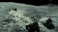 two astronauts on the surface of the moon, with dust coming out of their feet