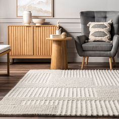 a living room with two chairs and a rug