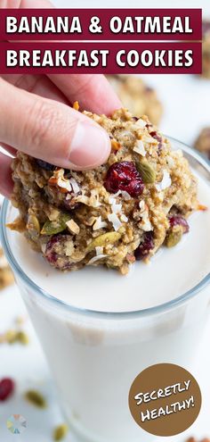 a hand is picking up some oatmeal breakfast cookies in a glass cup