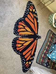 a butterfly rug is laying on the floor