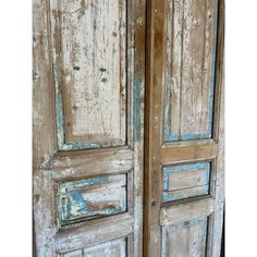 an old wooden door with peeling paint on it